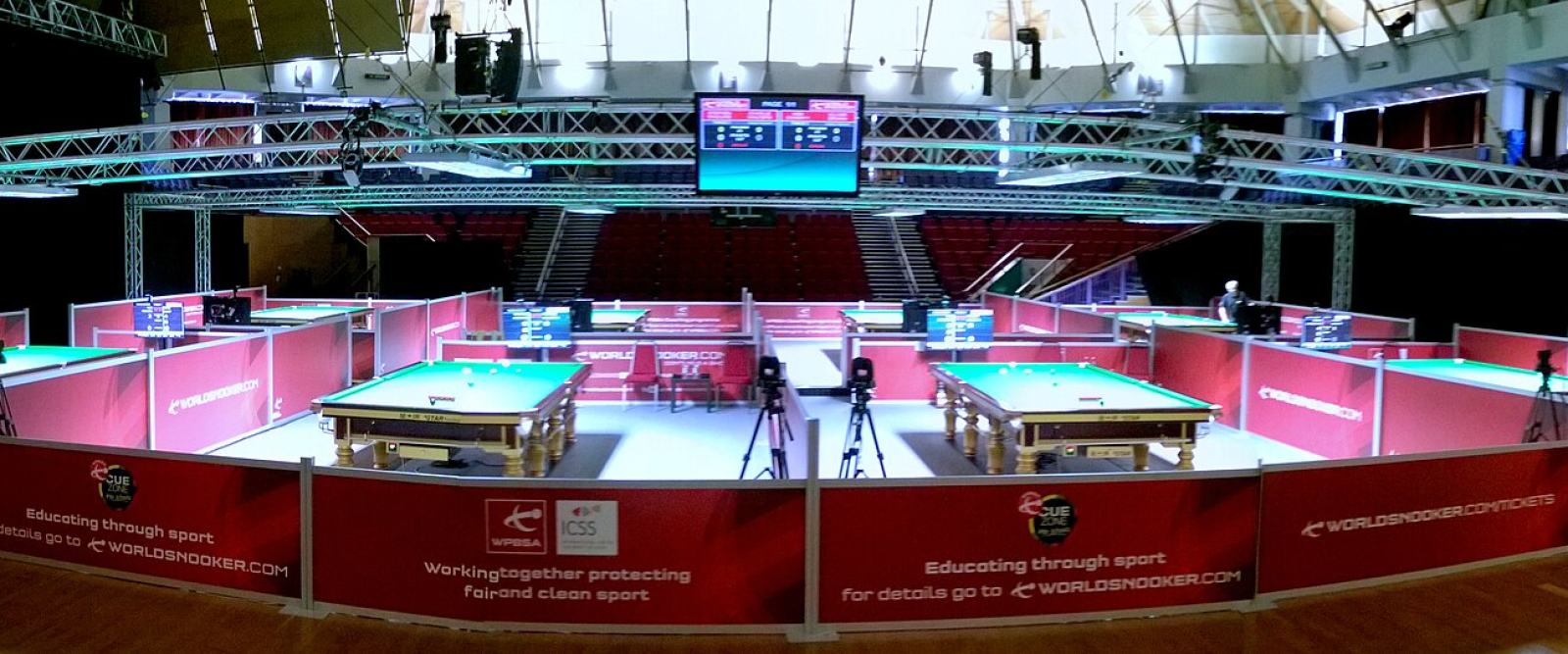 Snooker tables lit for play during a tournament qualifying stage